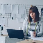 Small business owner doing a pricing review of client invoices