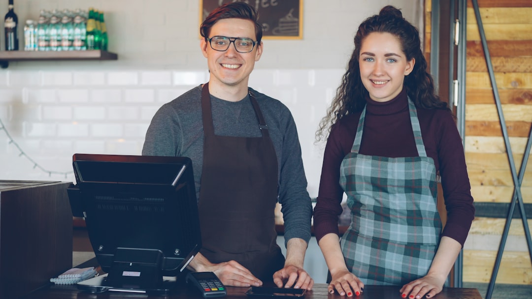 Small business owner discussing a referral program with a loyal customer