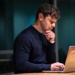 Product manager checking prompt engineering results on a laptop