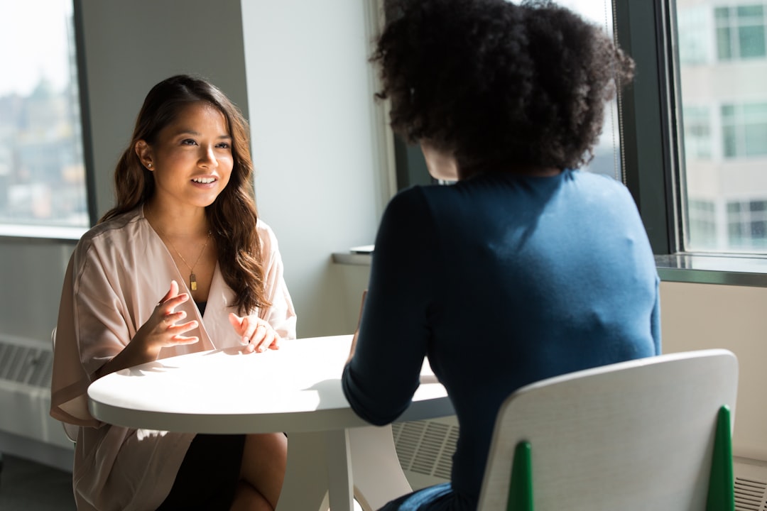 Two colleagues negotiating vendor contracts during an office meet