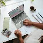 Finance manager reviewing a Q4 budget requests spreadsheet at a desk